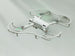 DJI Mini 3 Pro drone with white propeller guards hovering in the air against a plain background.