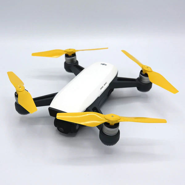 DJI Spark drone with STEALTH upgrade yellow propellers for improved flight performance and reduced noise.