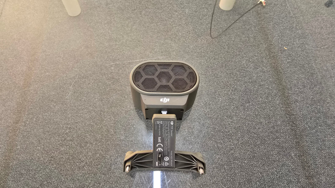 Pre-Owned DJI Mavic 2 Dual Speaker Module from above view on carpeted surface.